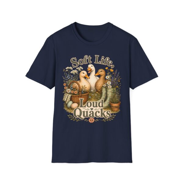 T-Shirt — "Soft Life, Loud Quacks" Cute Duck Graphic Tee one dramatic duck standing in shallow pond water with cattails, ripples, reeds, and a slightly judgmental expression. Give the duck a...