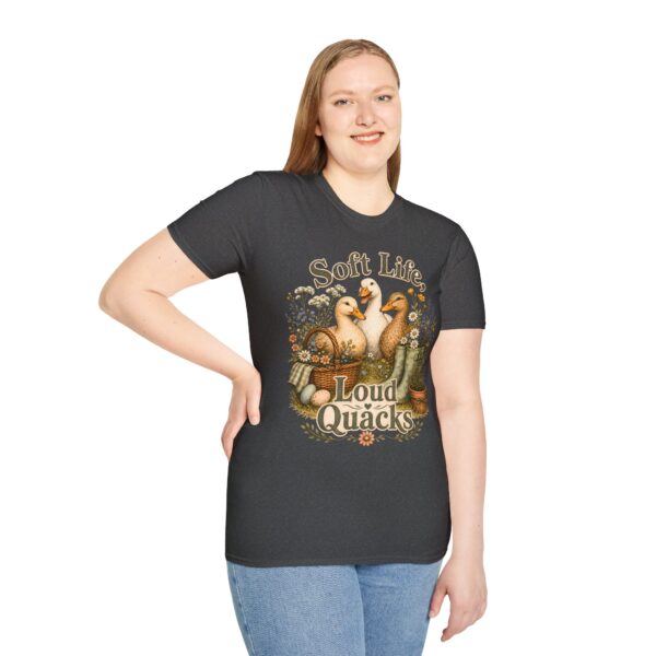 T-Shirt — "Soft Life, Loud Quacks" Cute Duck Graphic Tee one dramatic duck standing in shallow pond water with cattails, ripples, reeds, and a slightly judgmental expression. Give the duck a...