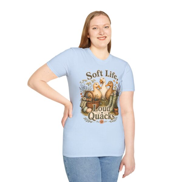 T-Shirt — "Soft Life, Loud Quacks" Cute Duck Graphic Tee one dramatic duck standing in shallow pond water with cattails, ripples, reeds, and a slightly judgmental expression. Give the duck a...