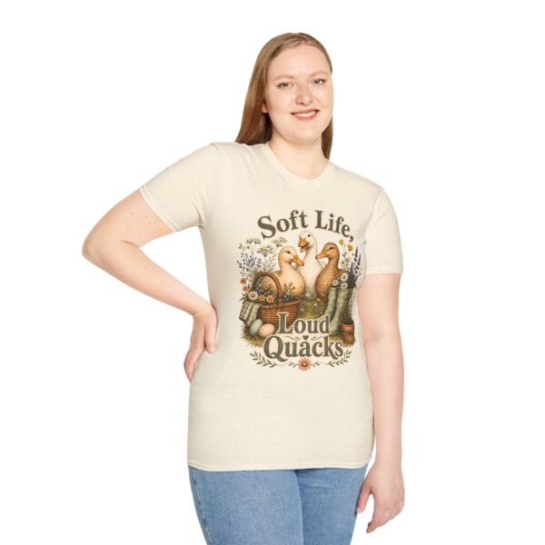 T-Shirt — "Soft Life, Loud Quacks" Cute Duck Graphic Tee one dramatic duck standing in shallow pond water with cattails, ripples, reeds, and a slightly judgmental expression. Give the duck a...