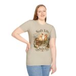 T-Shirt — "Soft Life, Loud Quacks" Cute Duck Graphic Tee one dramatic duck standing in shallow pond water with cattails, ripples, reeds, and a slightly judgmental expression. Give the duck a...