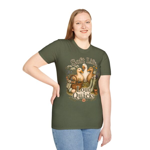 T-Shirt — "Soft Life, Loud Quacks" Cute Duck Graphic Tee one dramatic duck standing in shallow pond water with cattails, ripples, reeds, and a slightly judgmental expression. Give the duck a...