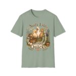 T-Shirt — "Soft Life, Loud Quacks" Cute Duck Graphic Tee one dramatic duck standing in shallow pond water with cattails, ripples, reeds, and a slightly judgmental expression. Give the duck a...