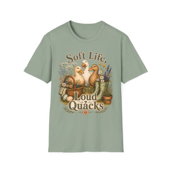 T-Shirt — "Soft Life, Loud Quacks" Cute Duck Graphic Tee one dramatic duck standing in shallow pond water with cattails, ripples, reeds, and a slightly judgmental expression. Give the duck a...