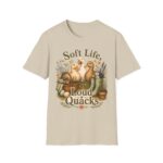T-Shirt — "Soft Life, Loud Quacks" Cute Duck Graphic Tee one dramatic duck standing in shallow pond water with cattails, ripples, reeds, and a slightly judgmental expression. Give the duck a...