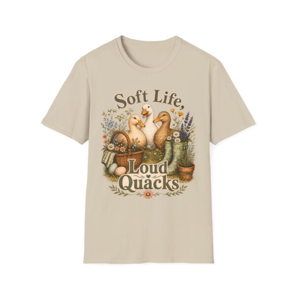 T-Shirt — "Soft Life, Loud Quacks" Cute Duck Graphic Tee one dramatic duck standing in shallow pond water with cattails, ripples, reeds, and a slightly judgmental expression. Give the duck a...