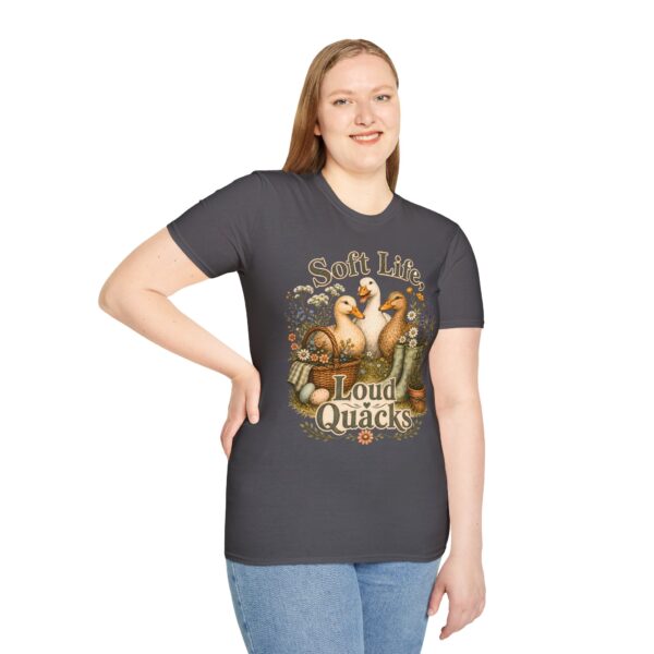T-Shirt — "Soft Life, Loud Quacks" Cute Duck Graphic Tee one dramatic duck standing in shallow pond water with cattails, ripples, reeds, and a slightly judgmental expression. Give the duck a...