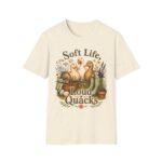 T-Shirt — "Soft Life, Loud Quacks" Cute Duck Graphic Tee one dramatic duck standing in shallow pond water with cattails, ripples, reeds, and a slightly judgmental expression. Give the duck a...