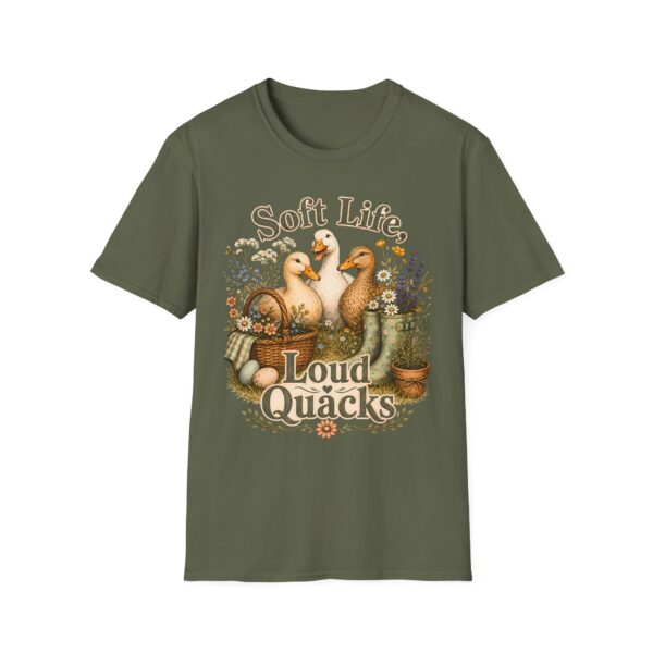 T-Shirt — "Soft Life, Loud Quacks" Cute Duck Graphic Tee one dramatic duck standing in shallow pond water with cattails, ripples, reeds, and a slightly judgmental expression. Give the duck a...