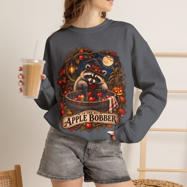 Crewneck Sweatshirt — "The Apple Bobber" Halloween Raccoon Apple-Bobbing Design