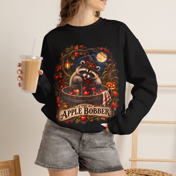 Crewneck Sweatshirt — "The Apple Bobber" Halloween Raccoon Apple-Bobbing Design