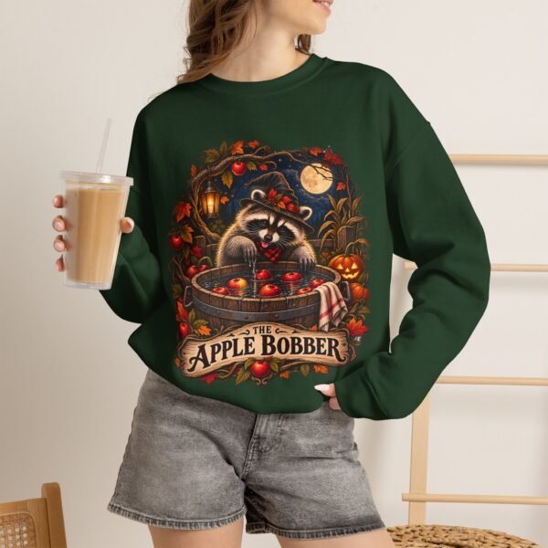 Crewneck Sweatshirt — "The Apple Bobber" Halloween Raccoon Apple-Bobbing Design