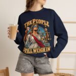 Crewneck Sweatshirt — "The People Still Weigh In" Lady Justice Graphic